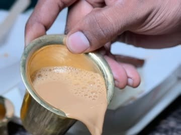 Filter coffee being poured, Chennai style